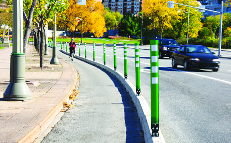 Separated bike lane with flexible bollard delineator post and pre-cast concrete curbs - National Capital Commission, Ottawa, ON