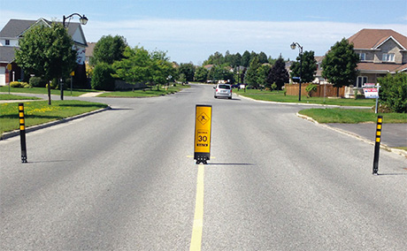 Traffic calming exemple with sign and bollards - City of Ottawa