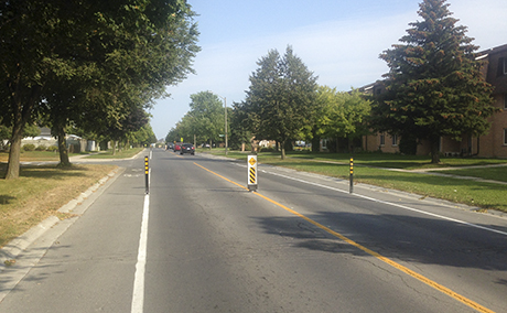 Speed reduction measure with signs and bollards - Collector road - City of Kingston