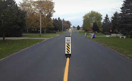 Traffic calming measure with sign - Countryside road