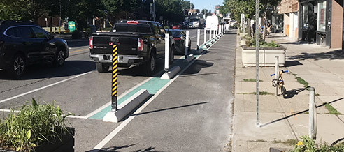 Bike lane with flexible bollard on pre-cast concrete curbs