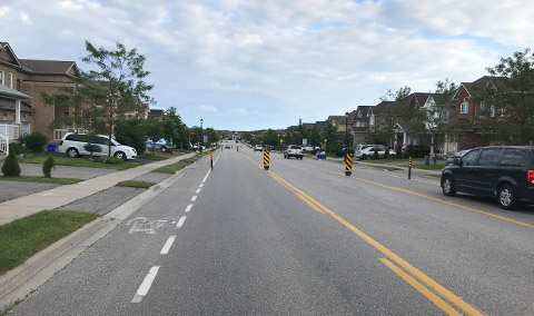 Traffic Calming measure with signs and bollards - arterial road - Town of Newmarket