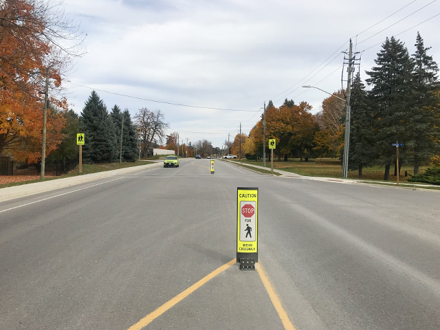 In-street flexible pedestrian crossoverbsign