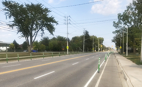 Bike lane with flexible bollard delineators to prevent / avoid parking on the bike lane